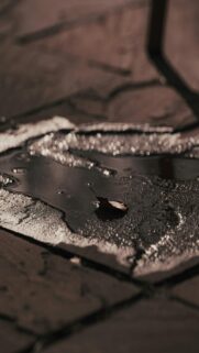 Single Leaf Puddle Dark Pavement Mobile Wallpaper