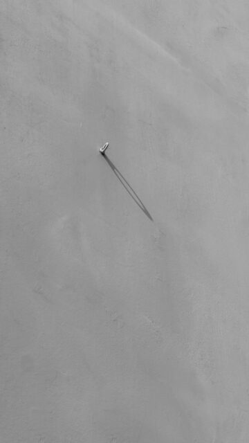 Shadowy Focus: A Single Nail on a Wall