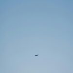 small-airplane-flying-clear-blue-sky