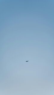 small-airplane-flying-clear-blue-sky