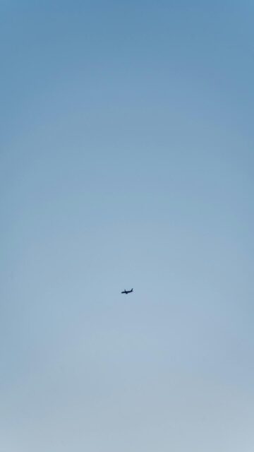 small-airplane-flying-clear-blue-sky