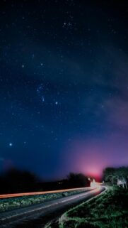 Starry Night Sky Over A Winding Road