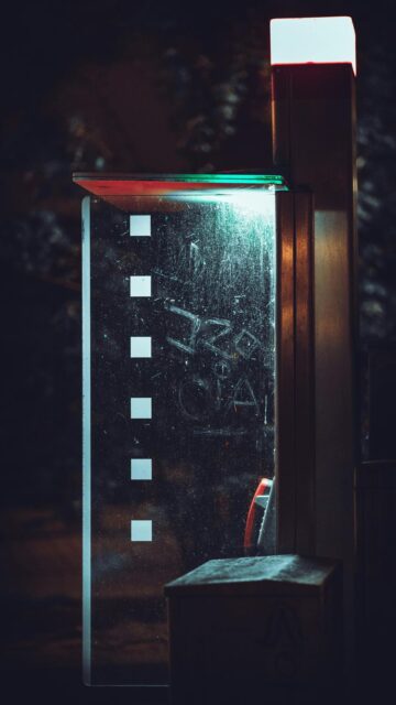 Vintage Phone Booth at Night with Graffiti