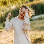 Blonde Woman in Cream Sweater Smiling