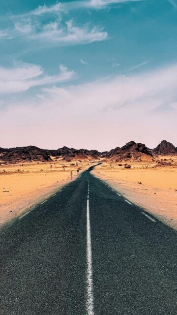 Endless Horizon: Desert Road to Mountainous Skies
