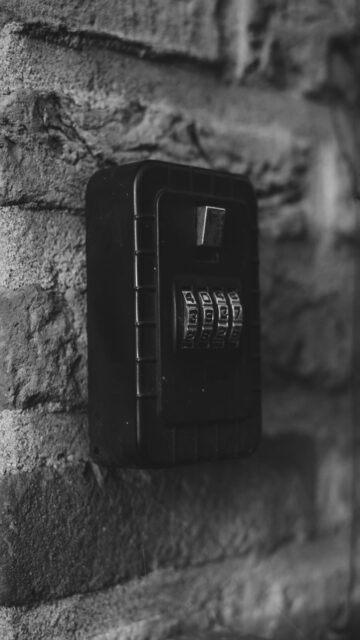 Secure Storage: Black Combination Lock Box on Brick Wall