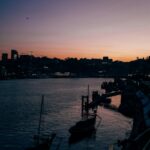 Cityscape at Dusk with Boats on Water
