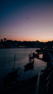 Cityscape at Dusk with Boats on Water