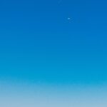 Stunning Ocean View: Bright Blue Sky and White Clouds
