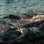 Waves Crashing on Rocks at Sunset