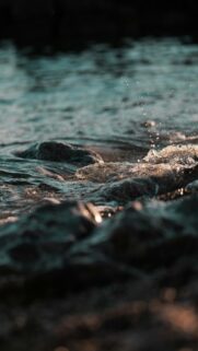 Waves Crashing on Rocks at Sunset