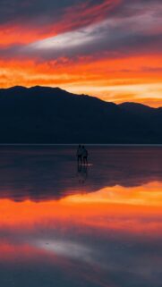 Sunset Reflections: Couple Standing On Water