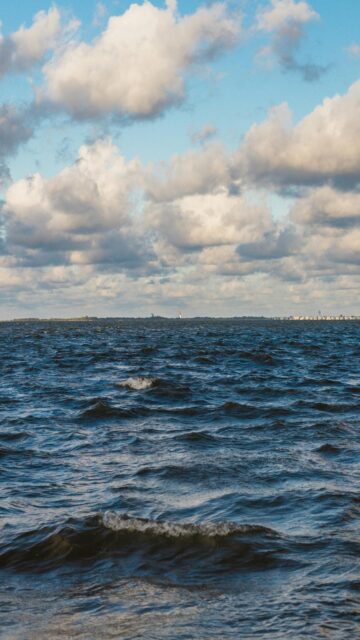 Moody Ocean Waves Under Cloudy Sky