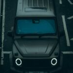 Glowing Headlights on Wet Road - Dark Grey SUV Wallpaper