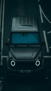 Glowing Headlights on Wet Road – Dark Grey SUV Wallpaper