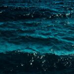 Deep Blue Ocean Waves with Sparkling Sunlight Reflections