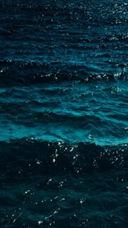 Deep Blue Ocean Waves with Sparkling Sunlight Reflections