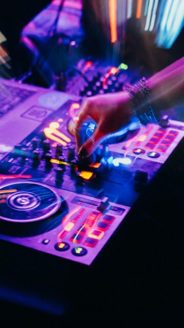 Electric Vibe: DJ Mixing Music with Colorful Lights