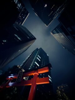 Dramatic View Of Tokyo Skyscrapers And A Red Torii Gate Under A Night Sky Captured From Below – Free 4K HD Download