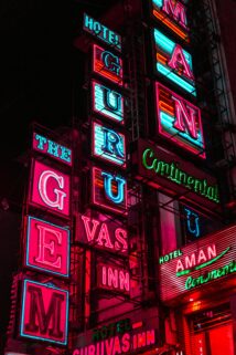 Dynamic Neon Signs Illuminate The Night Advertising City Hotels With Vivid Colors – Free 4K HD Download