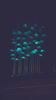 Glowing Nighttime Landscapes: Blue Umbrellas