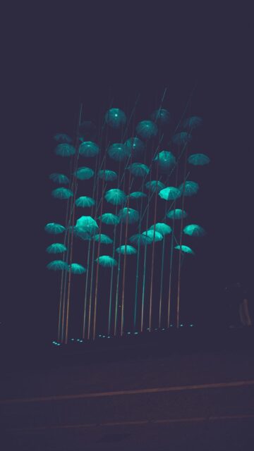 Glowing Nighttime Landscapes: Blue Umbrellas