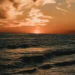 golden-sunset-over-dark-ocean-waves-mobile-wallpaper