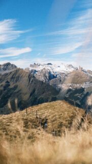 snow-capped-peaks-on-grassy-mountain-ridge