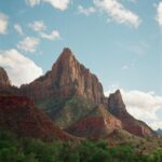 Majestic Sandstone Mountains Under Cloudy Blue Sky