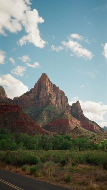 Majestic Sandstone Mountains Under Cloudy Blue Sky