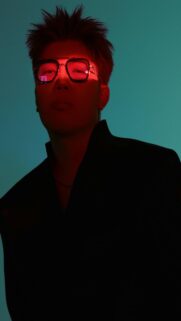 Eerie Figure in Dark Clothing with Red Glow