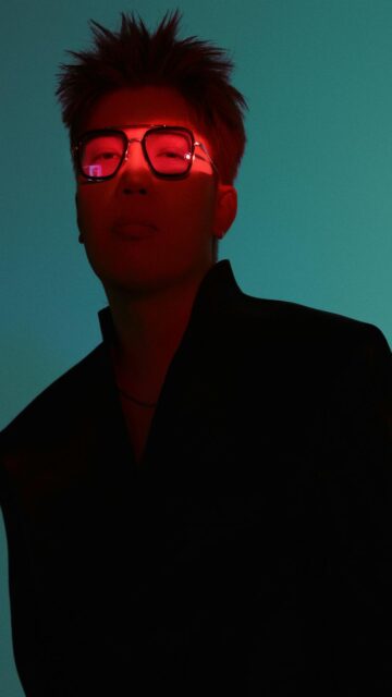 Eerie Figure in Dark Clothing with Red Glow