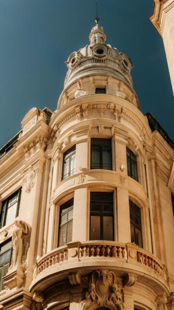 Ornate Building with Dome and Balcony under Blue Sky