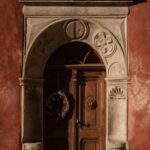 Rustic Door with Wreath on Red Background