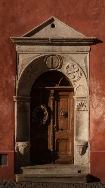 Rustic Door with Wreath on Red Background