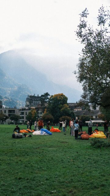 Paragliding Adventure: People Preparing on a Lush Field