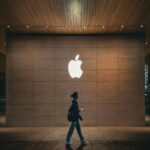 Illuminated Apple Logo on Wall for Mobile Wallpaper