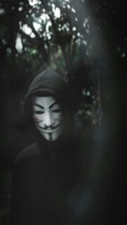 Guy Fawkes Mask in Dark Forest Wallpaper