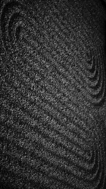 Raked Sand With Swirling Patterns In Black And White