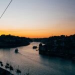 Serenene River Sunset with Boats and Cityscape