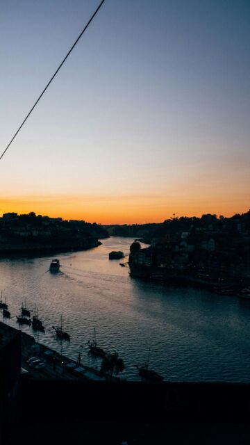 Serenene River Sunset with Boats and Cityscape