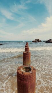 Beach Vibes: Ocean Waves Meet Rusty Posts