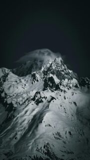 Snowy Mountain Peak Wrapped in Clouds