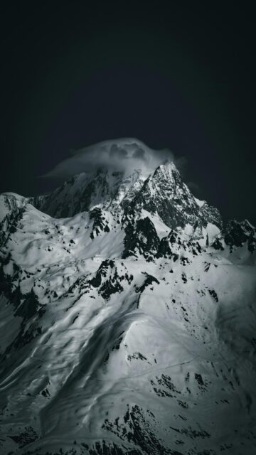 Snowy Mountain Peak Wrapped in Clouds