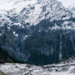 Breathtaking Winter Landscape: Snowy Mountains and Serene Stream