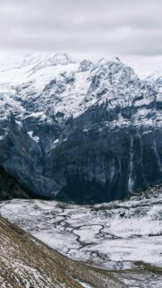Breathtaking Winter Landscape: Snowy Mountains and Serene Stream