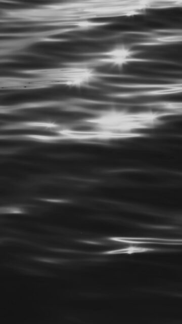 Mobile Wallpaper: Sunlight on Dark Water Ripples