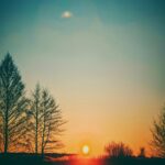 stunning-sunset-over-field-with-silhouetted-trees