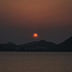Soothing Mobile Wallpaper: Sunset Over Dark Mountains And Calm Water