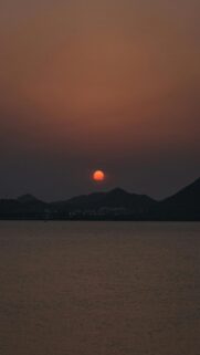 Soothing Mobile Wallpaper: Sunset Over Dark Mountains And Calm Water